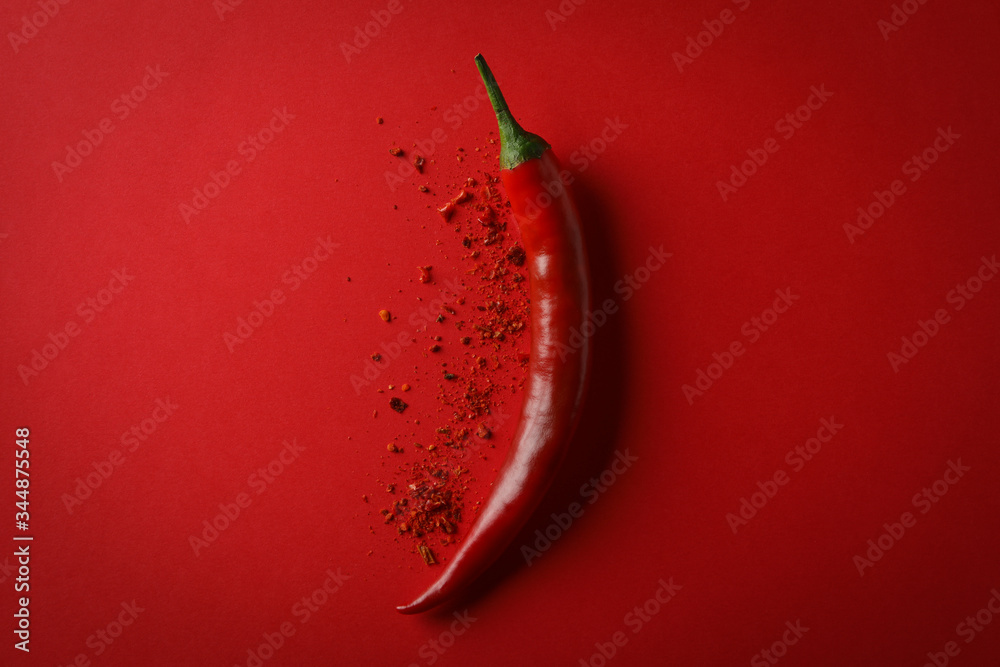 Tasty chilli pepper and powder spice on red background - obrazy, fototapety, plakaty 