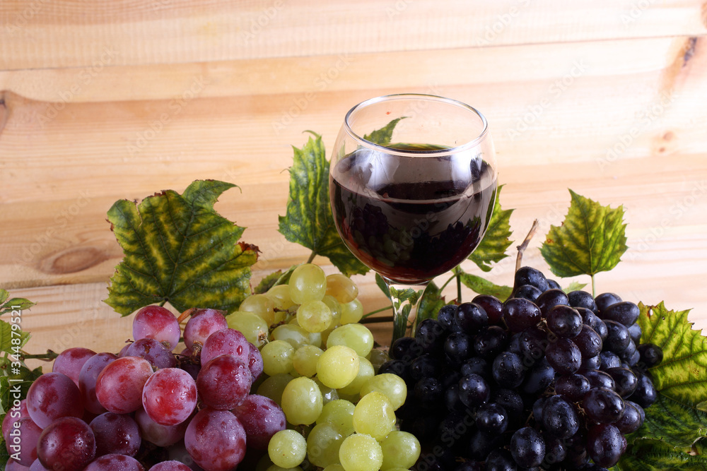 Grape and wine on table