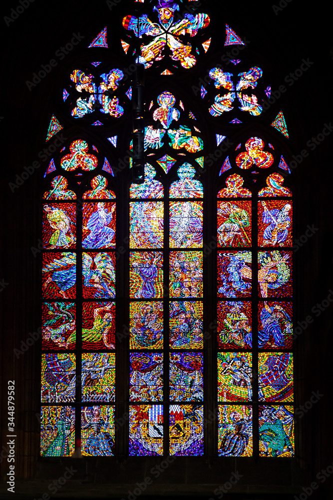 Colored stained glass windows of a medieval Gothic cathedral