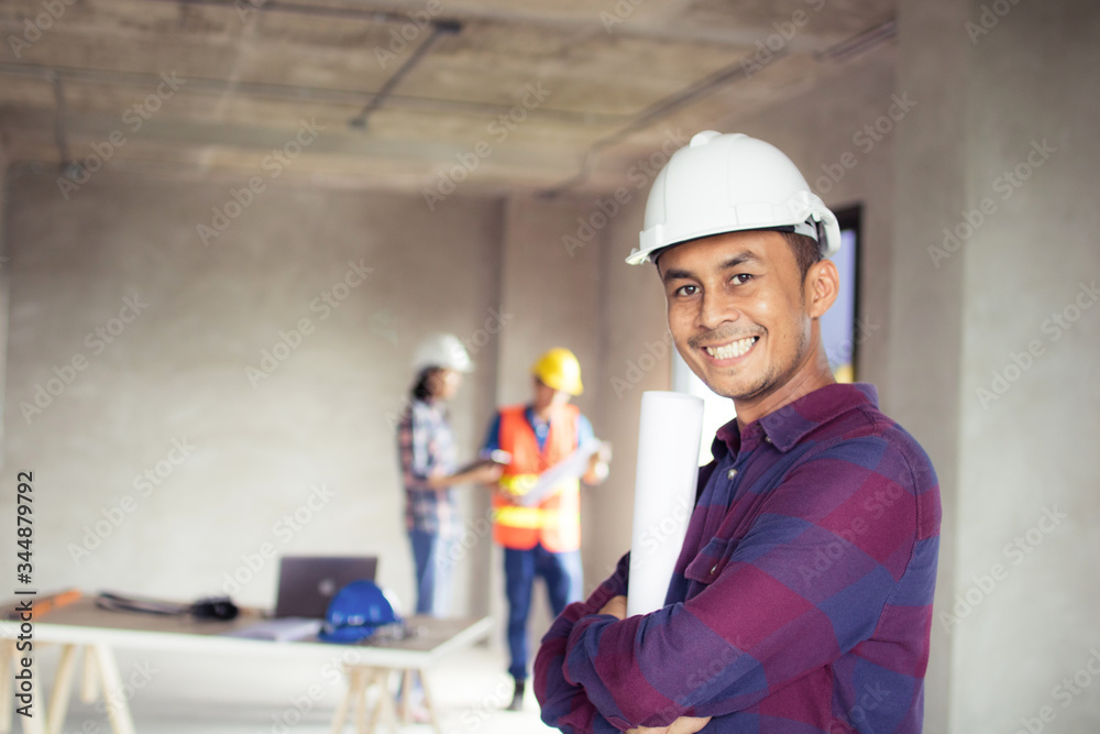 portrait engineer holding blueprint in construction site with architect and worker working background portrait engineer holding blueprint in construction site with architect and worker working background