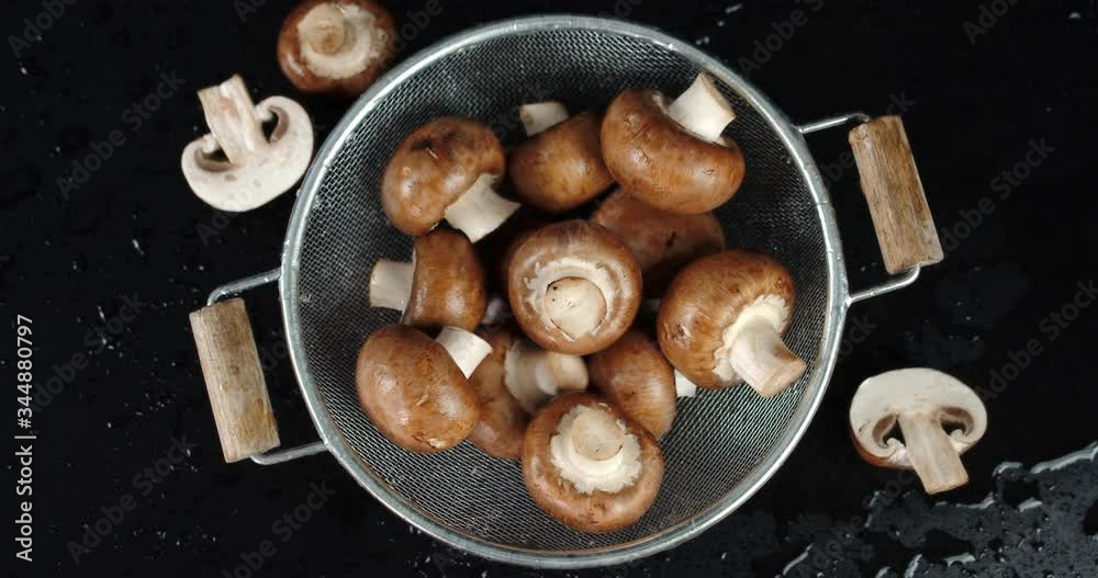 Fresh forest mushrooms in a colander slowly rotate. Fresh forest mushrooms in a colander slowly rotate.