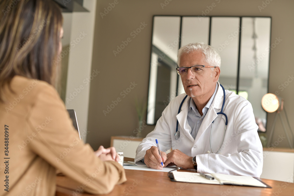 Fototapeta premium Doctor attending patient in office