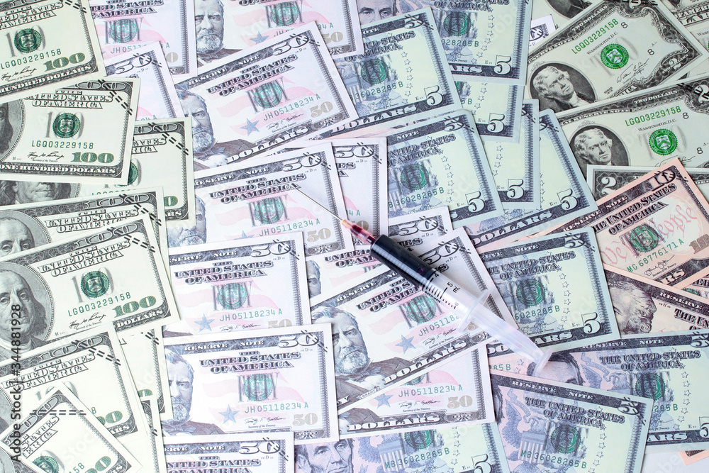 Varites dollar money and blood in syringe on banknotes lay spread double. Varites dollar money and blood in syringe on banknotes lay spread double.