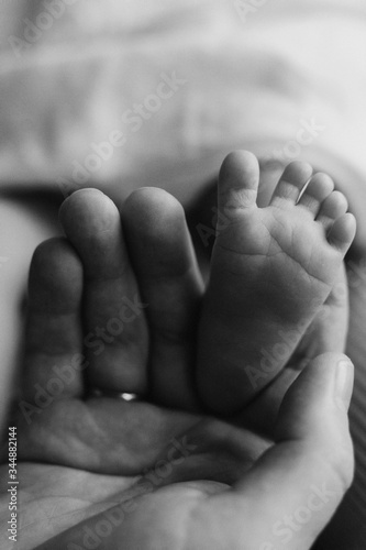 heels of a newborn in daddy's hands close-up