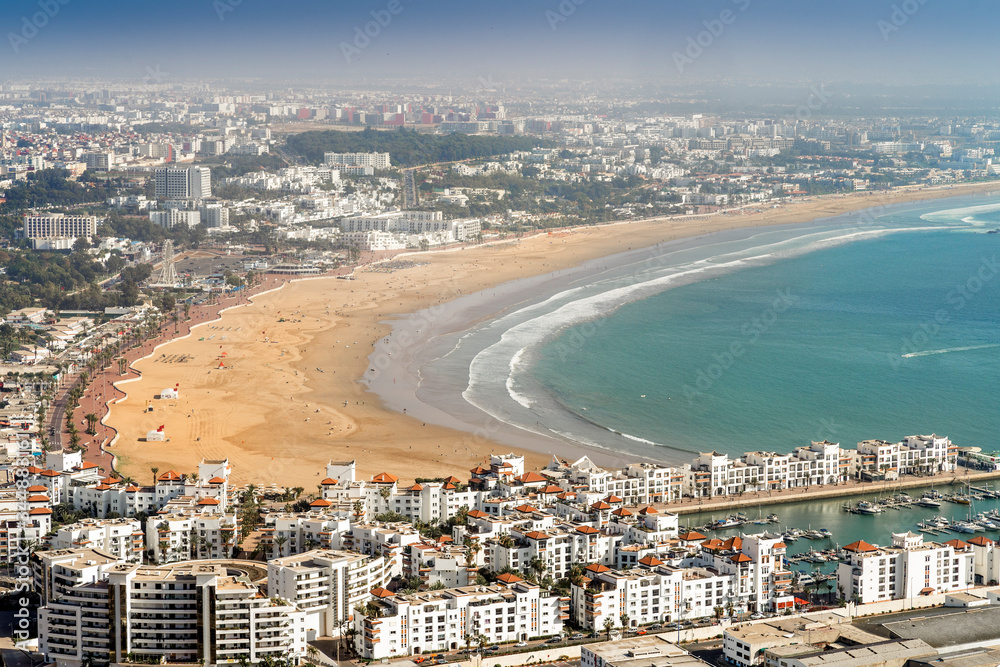 White modern architecture surrounding amazingly wide sandy beach in Agadir, Morocco