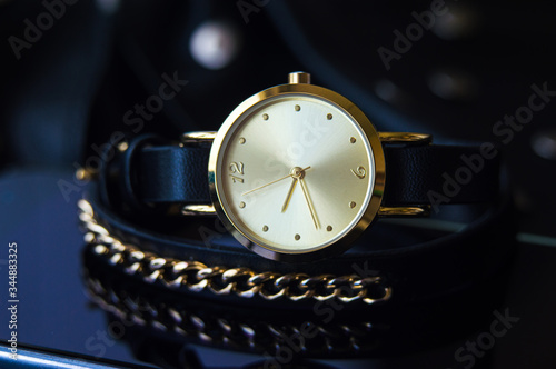 Watch with a leather strap and chain round dial in black and blue colors with space for text background