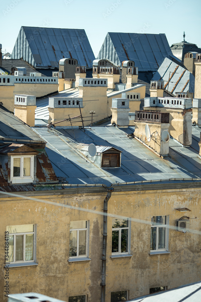 Roofs of houses in the city Saint-Petersburg. Beautiful views from the ancient roof. Walking on the rooftops of St. Petersburg. Russia. Old windows of the city Roofs of houses in the city Saint-Petersburg. Beautiful views from the ancient roof. Walking on the rooftops of St. Petersburg. Russia. Old windows of the city