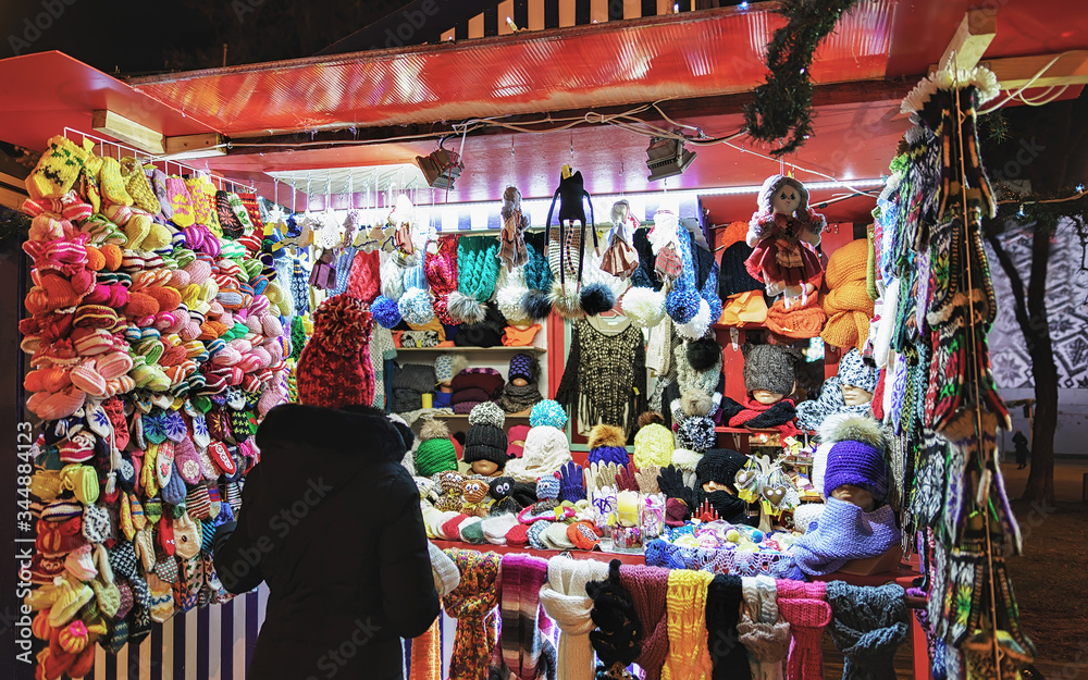 Colorful woolen clothes and consumer at Riga Street Christmas Market