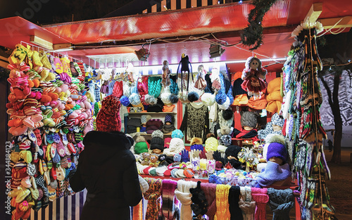 Colorful woolen clothes and consumer at Riga Street Christmas Market © Roman Babakin
