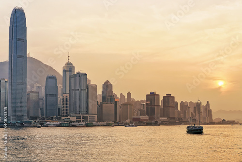 Star ferry at Victoria Harbor in Hong Kong at sundown