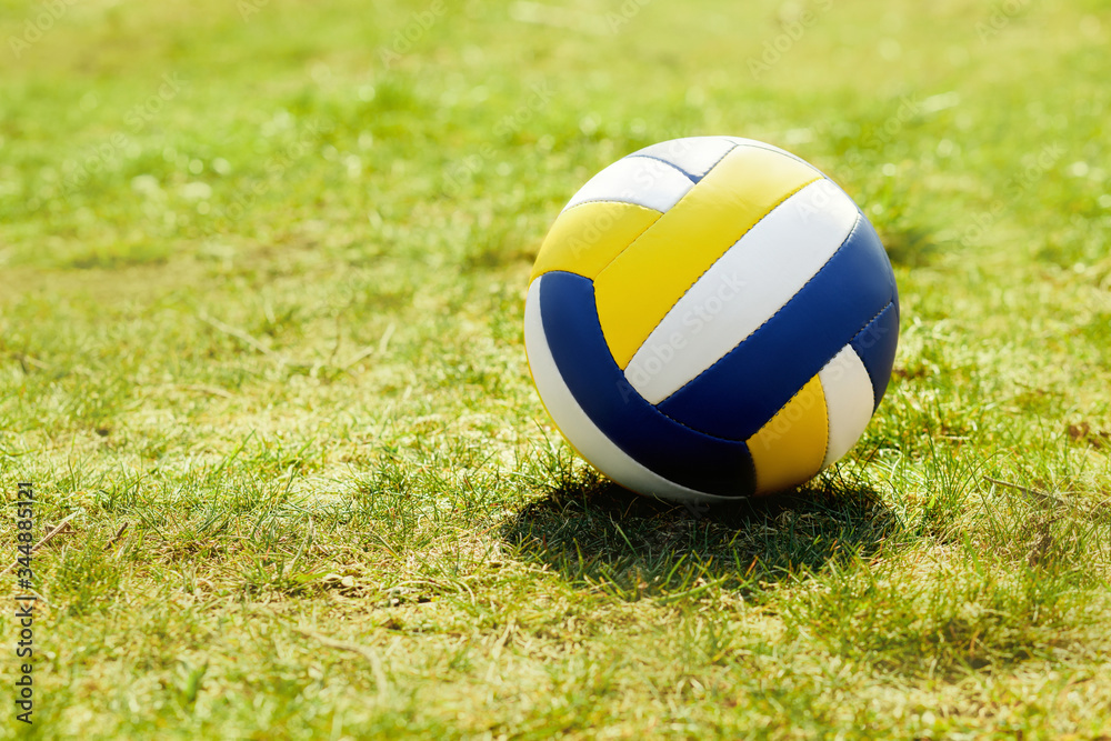 volleyball ball standing on the grass. Volleyball ball on greenery field in park volleyball ball standing on the grass. Volleyball ball on greenery field in park