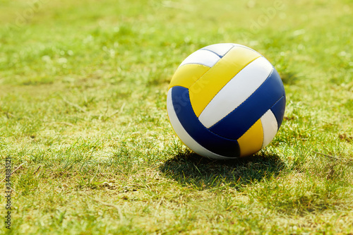 volleyball ball standing on the grass. Volleyball ball on greenery field in park
