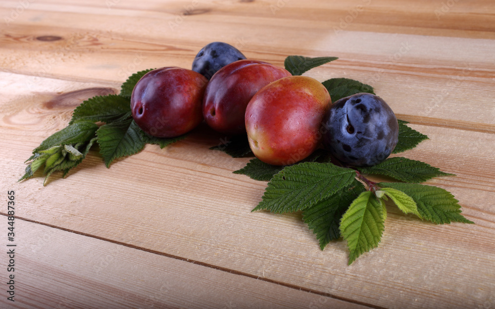 Different color plums on table