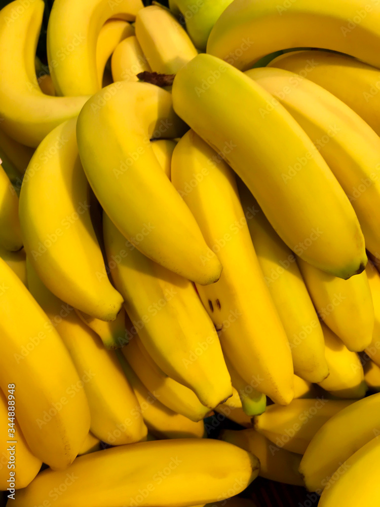 bunch of ripe bananas on one of which is a smiling smiley