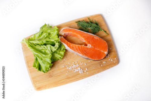 salmon steak is isolated on a white background. The concept of cooking. Grocery background.