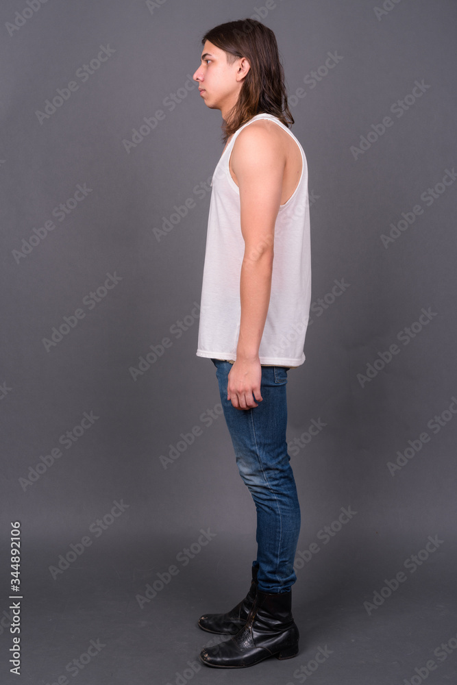 Young handsome androgynous man with long hair Young handsome androgynous man with long hair