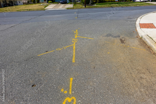 Fotografie Yellow markings on an asphalt street that show where the utility lines are berri