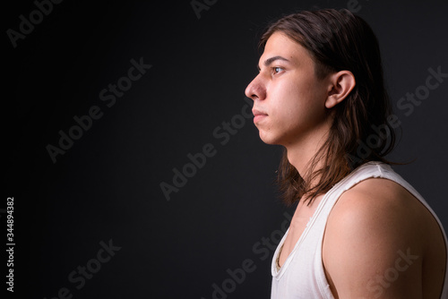 Young handsome androgynous man with long hair