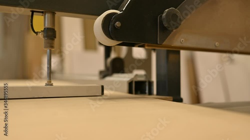Circular saw cutting furniture boards in the carpentry shop