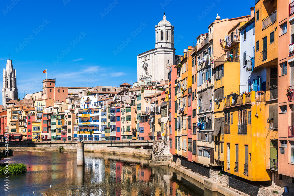 Colorful houses, Onyar river and Saint Mary Cathedral at background in Girona, Spain