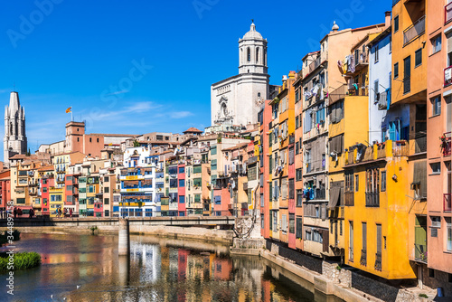 Colorful houses, Onyar river and Saint Mary Cathedral at background in Girona, Spain photo