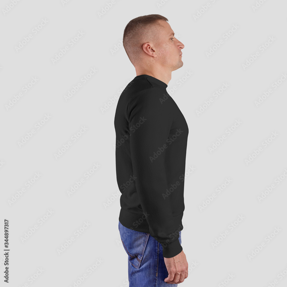 Mockup of black long-sleeved clothing on a man in blue jeans, side view, empty sweatshirt for presentation of design and advertising in the online store. Mockup of black long-sleeved clothing on a man in blue jeans, side view, empty sweatshirt for presentation of design and advertising in the online store.