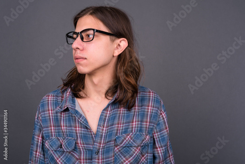 Young handsome hipster man with long hair