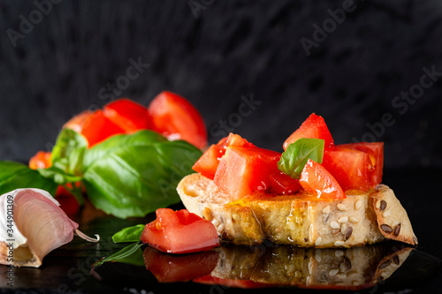 Olive oil over a bruschetta with tomatoes