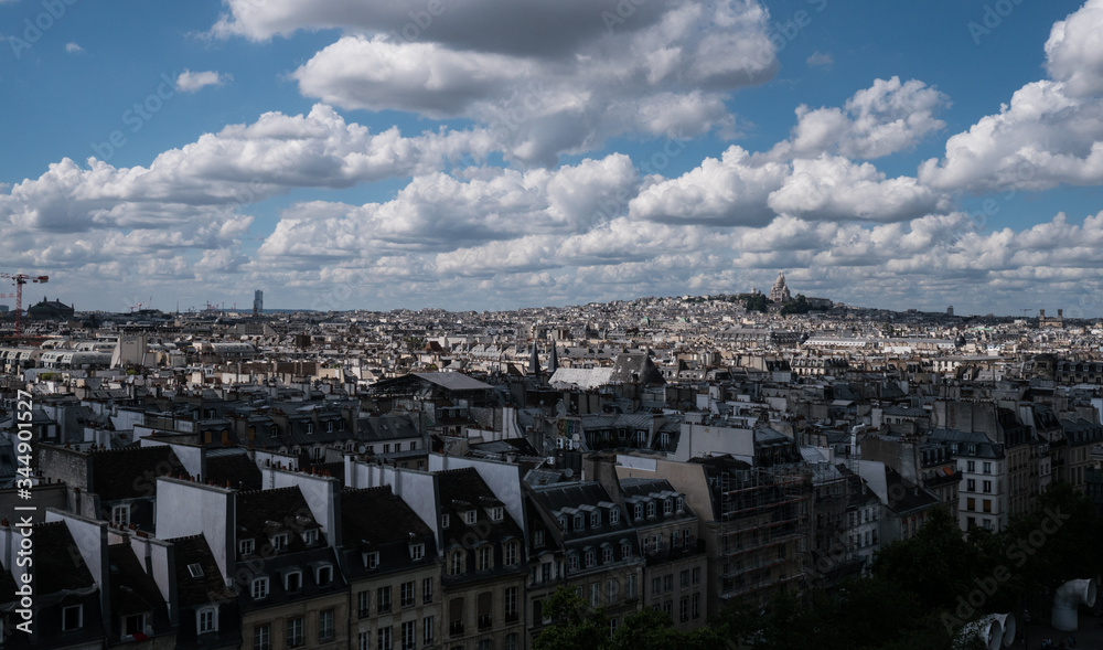 View over Paris with a incredible blue sky full of hanging clouds 