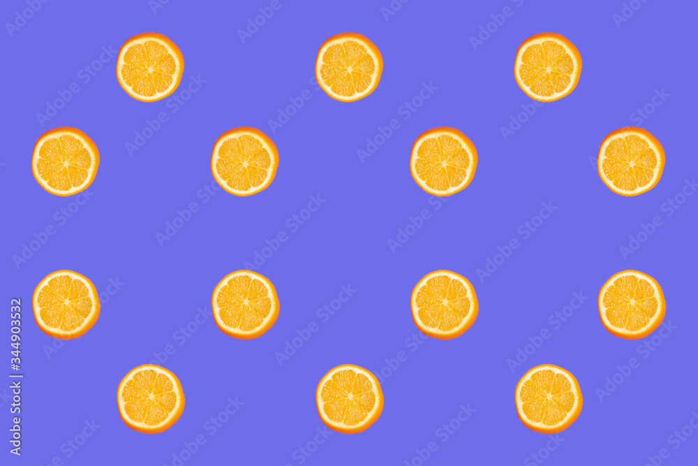 Colorful fruit pattern of fresh lemon slices on blue background. From top view