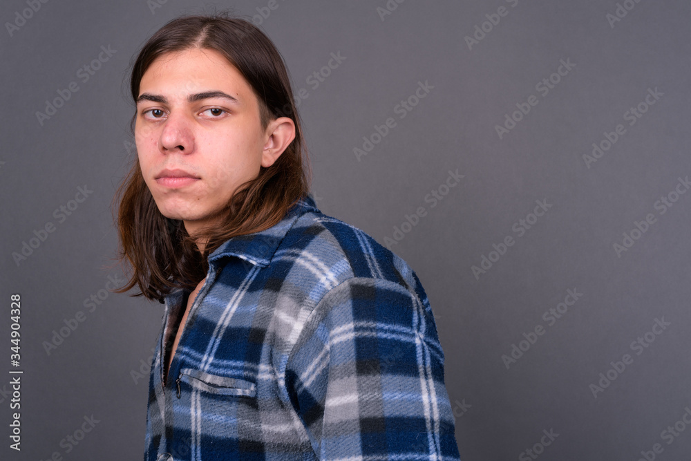 Obraz premium Young handsome hipster man with long hair
