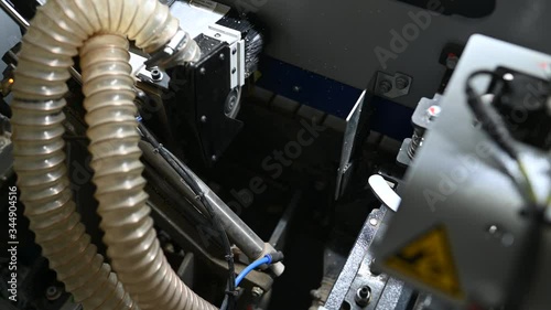 Furniture laminator. Operation of the laminating machine on the sides of furniture boards