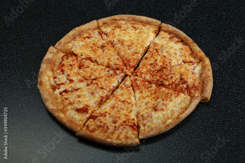 cheese pizza on dark background