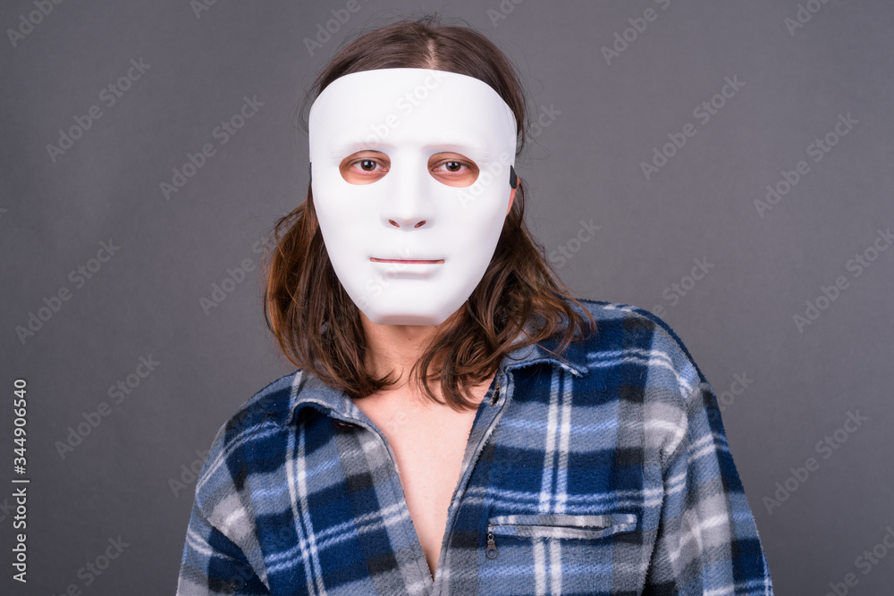 Young hipster man with long hair wearing mask Young hipster man with long hair wearing mask