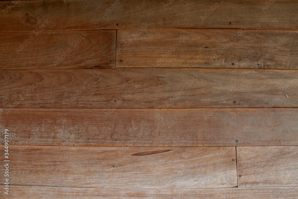 Fototapeta premium Teak wood wall in the house in northern Thailand that are almost a hundred years old. texture and background.