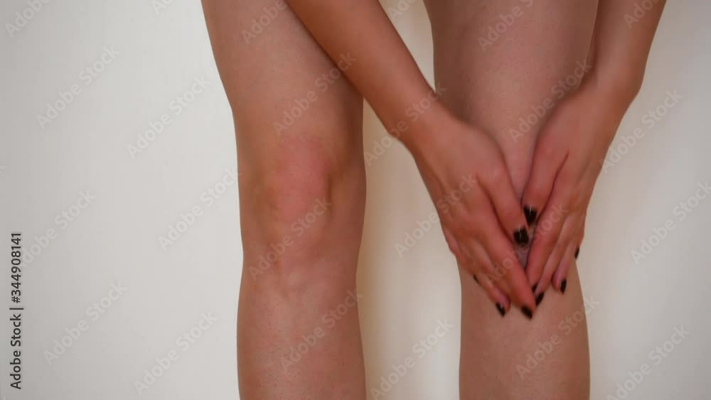 Woman knee massage after injury. Woman knee massage after injury.