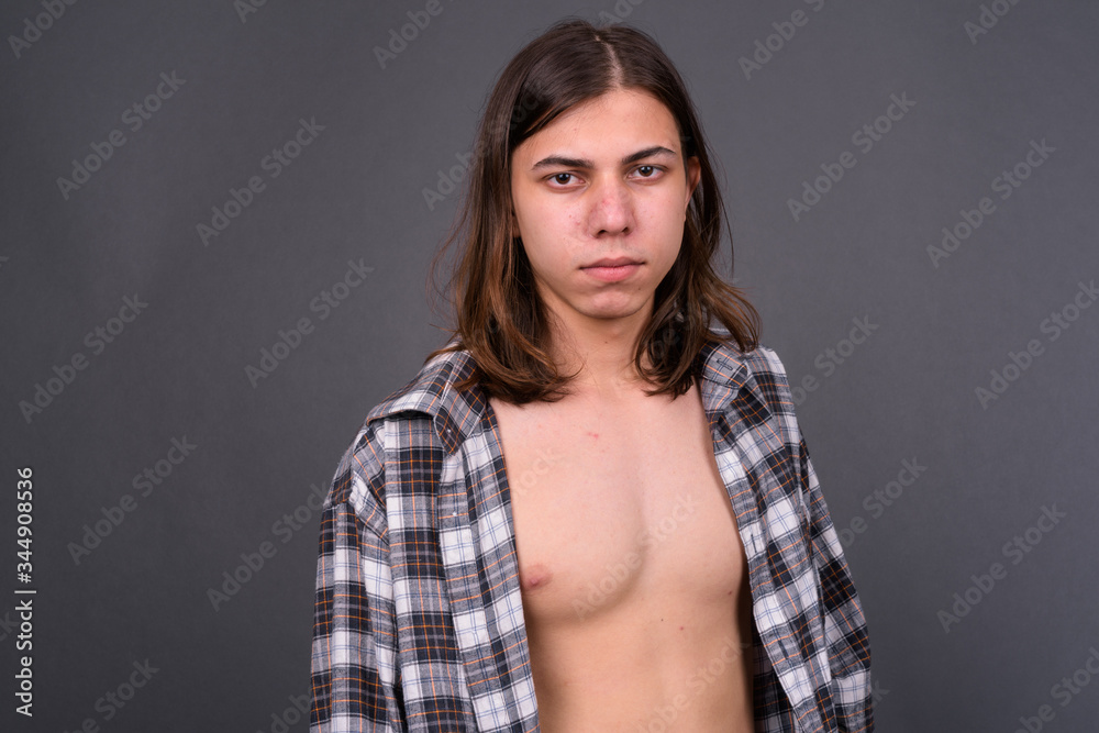 Young handsome androgynous man with shirt unbuttoned Young handsome androgynous man with shirt unbuttoned