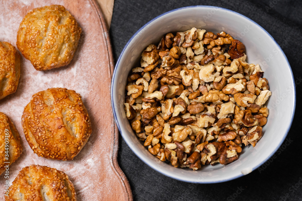 Baking, rolls, bread and sprinkled nuts. Kraft, food paper and wooden board Baking, rolls, bread and sprinkled nuts. Kraft, food paper and wooden board