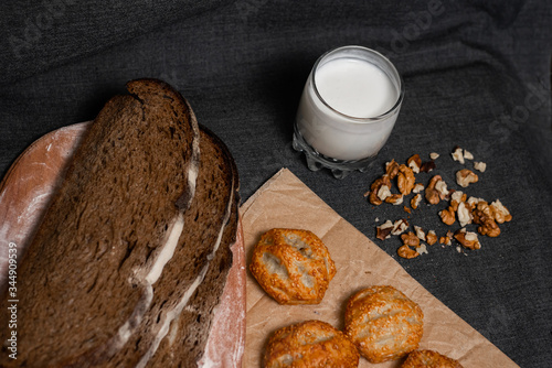 Baking, rolls, bread and sprinkled nuts. Kraft, food paper and wooden board