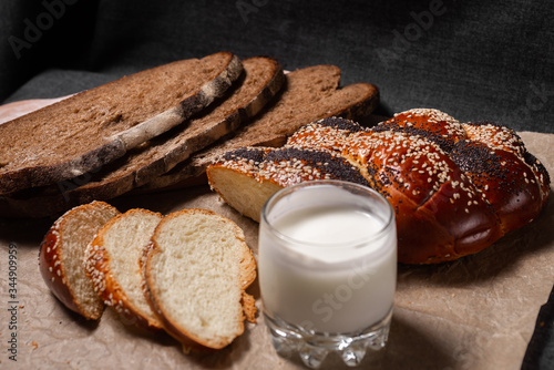 Baking, rolls, bread and milk on a dark background