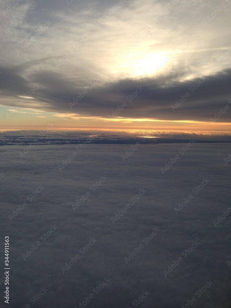 sunset over the sea from above the clouds