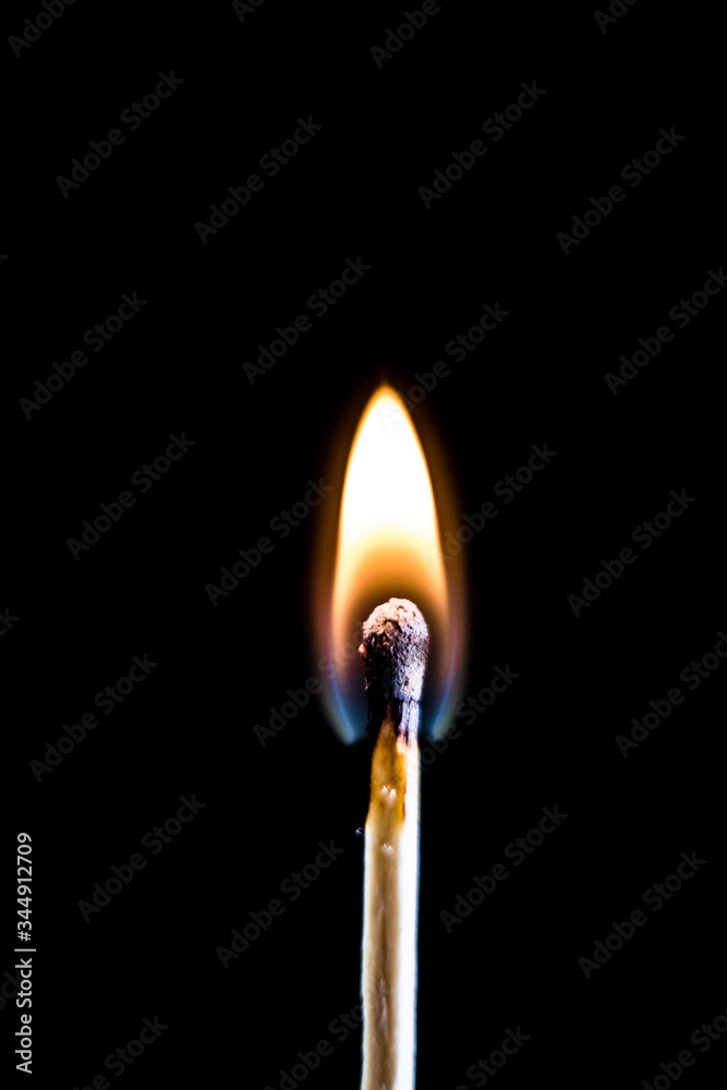 Burning match, on a black background. Macro shot,. Burning match, on a black background. Macro shot,.