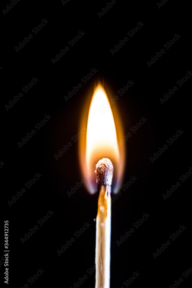 Burning match, on a black background. macro shot. Burning match, on a black background. macro shot.