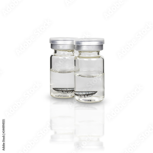 Contact lens in a clear glass bottle isolated on white background. with clipping paths.