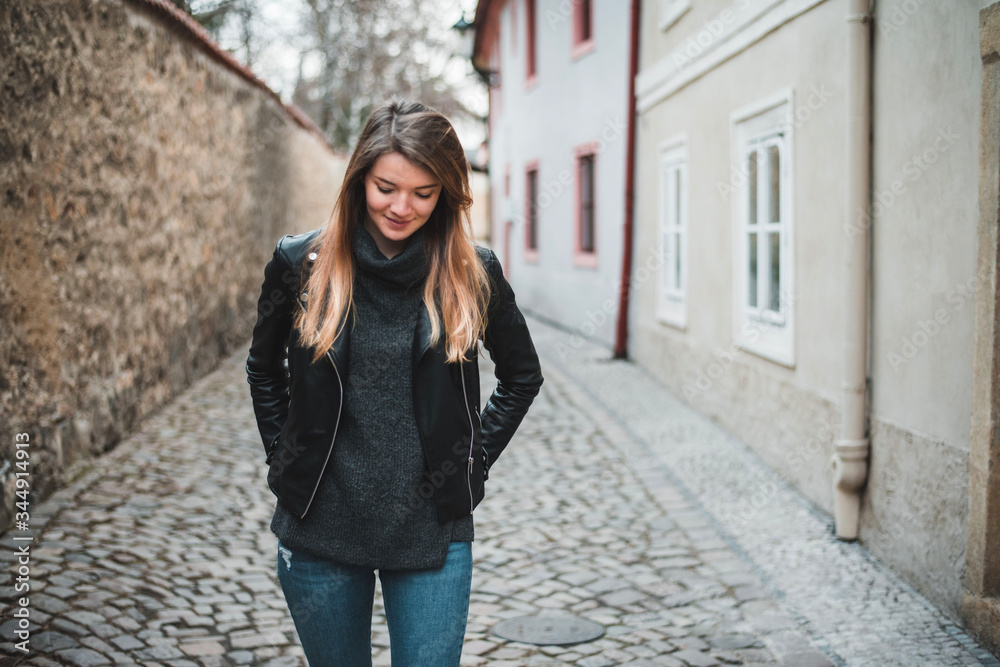 Woman walking through the empty streets of old Prague
