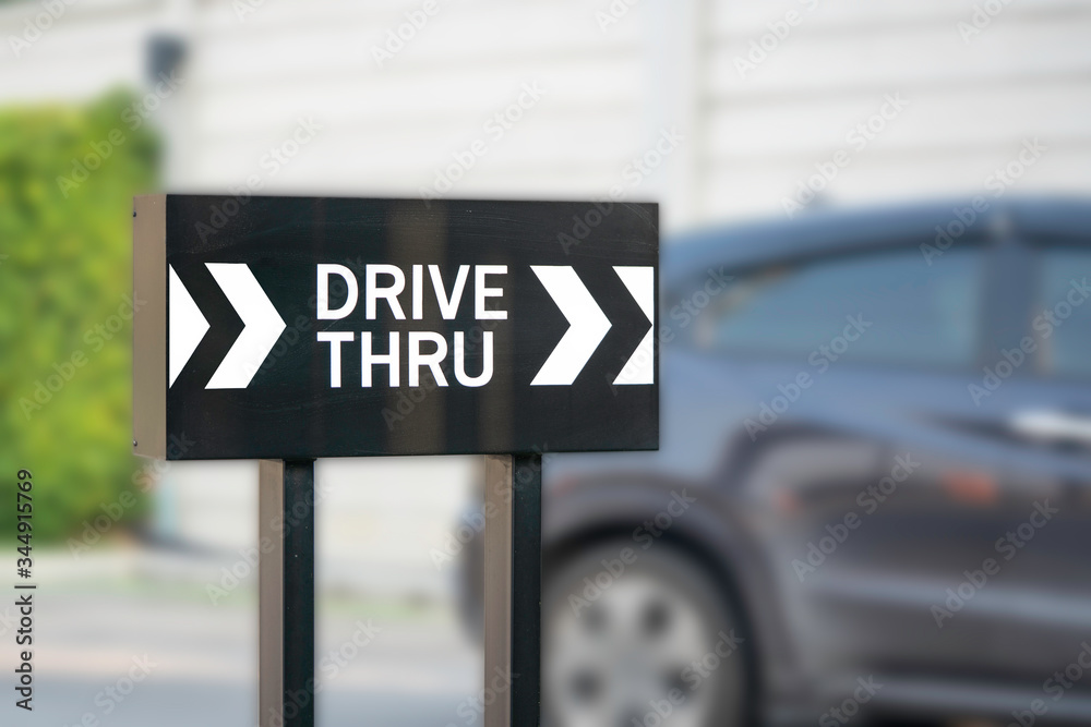 Drive thru or driving through sign with car background. Drive thru or driving through sign with car background.