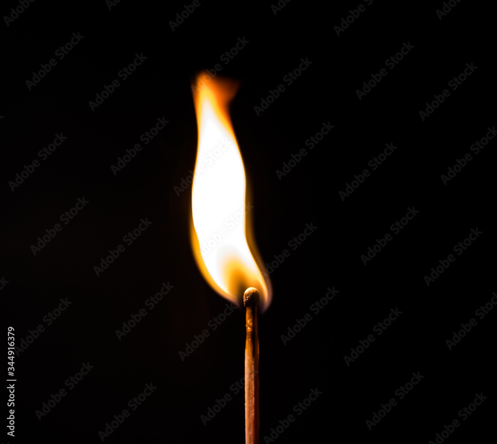 burning match on black background burning match on black background