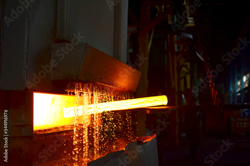 Foto Steel quenching at high temperature in industrial furnace at the workshop of a forge plant