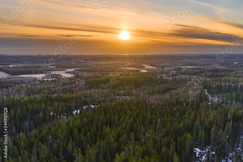 Aerial view of spring forest in Finland. North-Karelia nature. Sunset on the background.