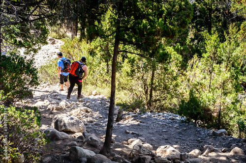 Person walking down the mountain on a sunny summer day. Bariloche.